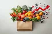 A bountiful array of fresh vegetables is shown next to a rising arrow indicating cost increases.
